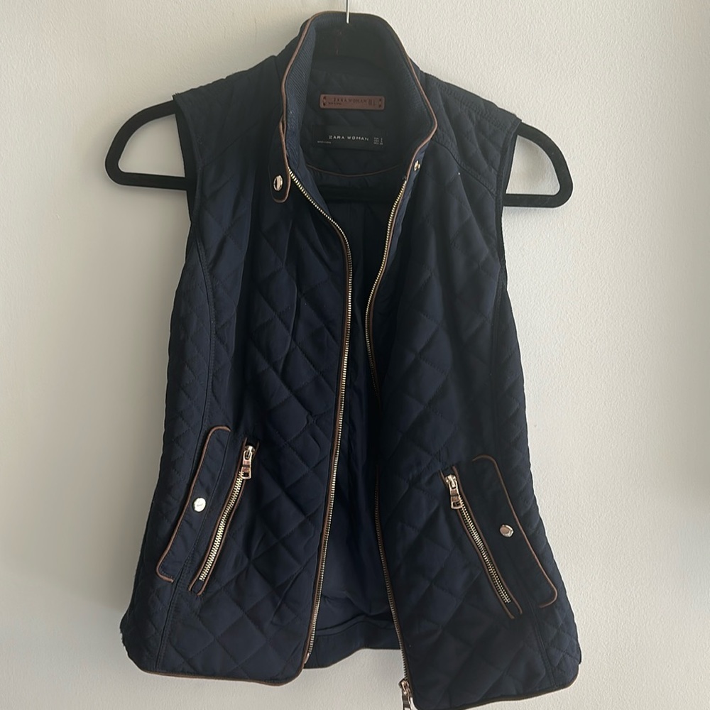 Equestrian-style navy blue vest with brown trim